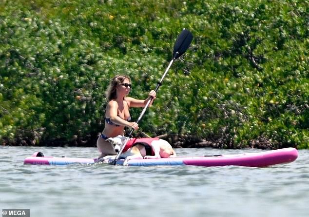 After the exhilarating rides, Sydney took some alone time to relax, taking out a paddleboard with her beloved dog, Tank