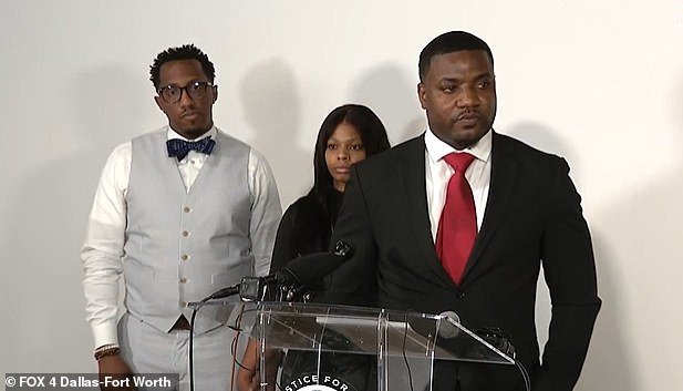 Karmelo Anthony's parents are seen behind their spokesman, minister Dominique Alexander on Thursday