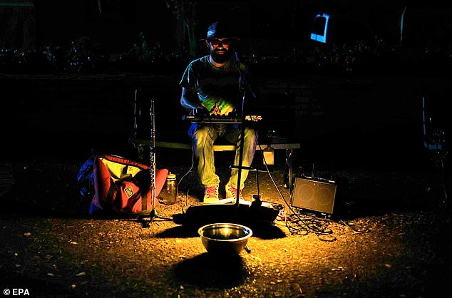 On Wednesday, major power plants across Puerto Rico began shutting down after a failure in a transmission line. A musician plays in a street during a power outage in San Juan