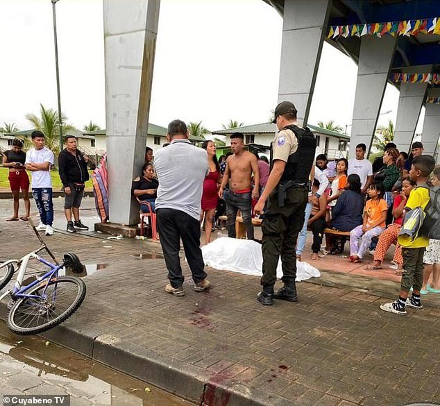 A British man is alleged to have been lynched in Ecuador after being linked to the shooting of a member of the local community (pictured: crowds gathered at what is thought to be the scene of the shooting)