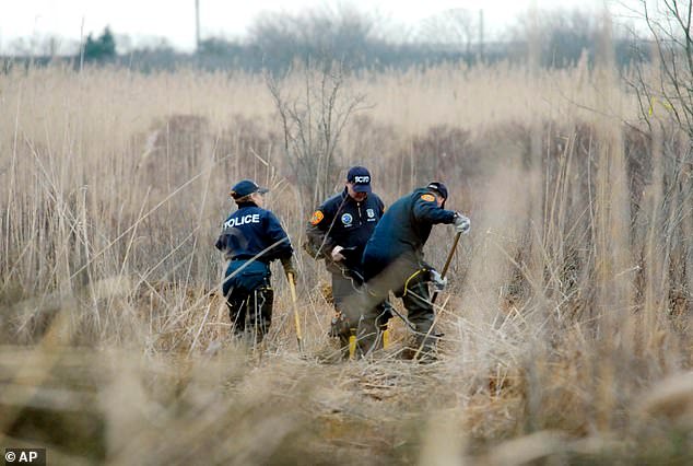 Police search a marsh in Oak Beach for the remains of Shannan Gilbert in December 2011