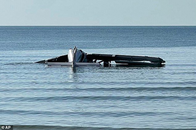 Pictured: The plane wreckage floating in the water after the crash
