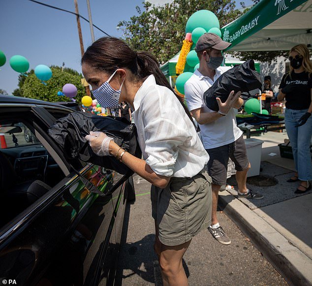The 71-year-old said Meghan and Harry have become 'disaster tourists' (Meghan is seen helping victims of the LA fires in January)