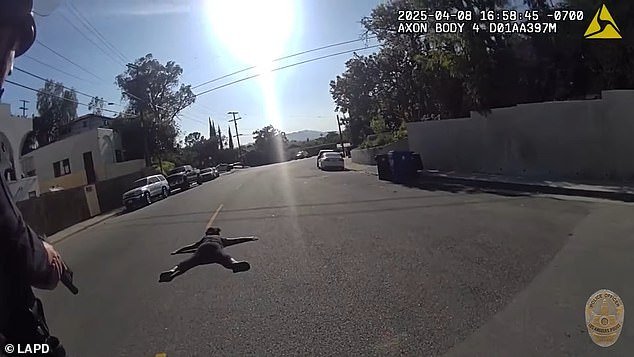She is seen laying on the ground shortly after being shot in the shoulder