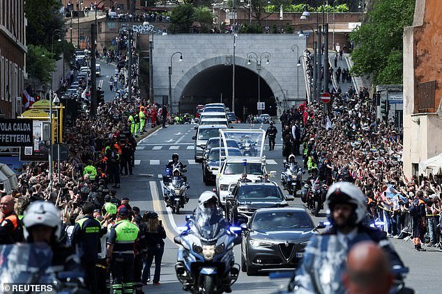 Thousands of people line the streets as the coffin is transferred to the Papal Basilica