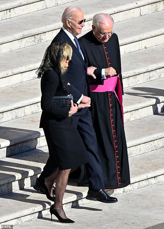 She added a pair of black sheer tights and pumps as outlined in the dress guidance, and carried a simple black clutch to the event