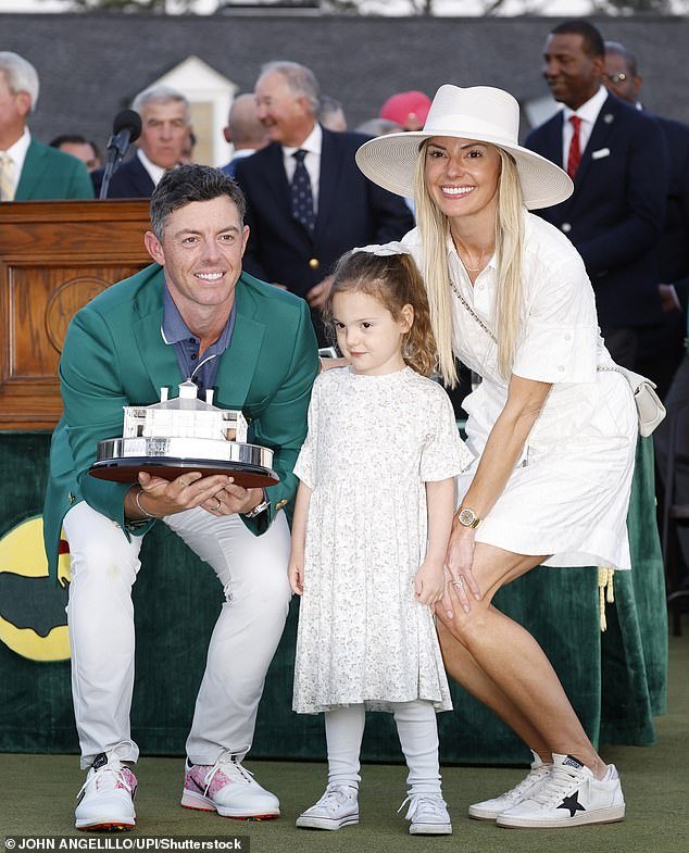Rory McIlroy of Northern poses with his wife Erica Stoll and daughter Poppy when he receives his Green Jacket after winning the 2025 Masters Tournament in Augusta, Georgia