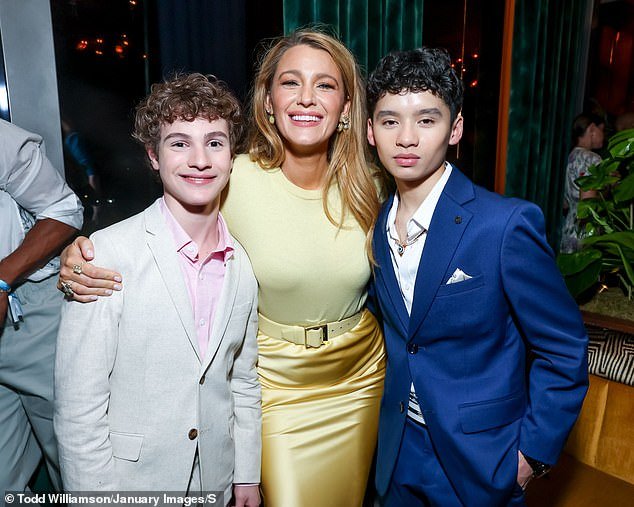 She completed the stylish ensemble with a belt that cinched her tiny waist (pictured with co-stars (L-R) Joshua Satine and Ian Ho)