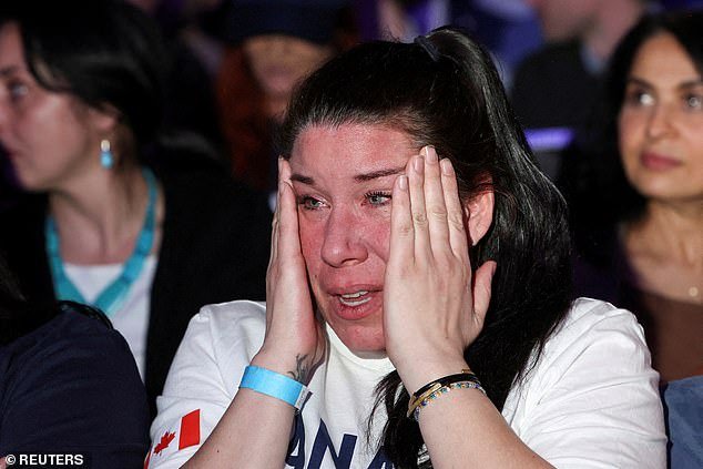 Amanda Mainville, a government worker and supporter of Conservative Party of Canada's leader Pierre Poilievre, reacts as news media calls the election for the Liberal Party