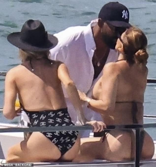 The Haitian American sportsman, who stands at a whopping 6'8", leaned over Larsa to plant a kiss on her as she sat on the deck
