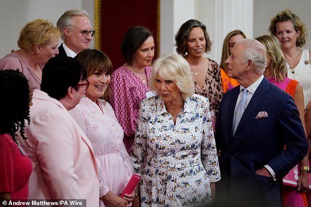 ing Charles III and Queen Camilla speak with presenter Lorraine Kelly (second left) and the members of the Change + Check Choir