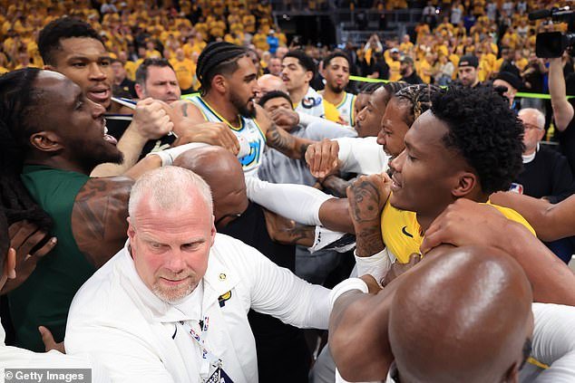 Security is seen working to separate Bucks and Pacers players after the first-round series