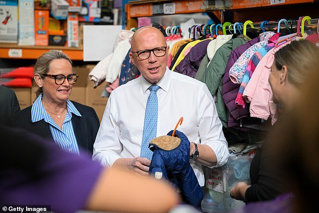 Peter Dutton wore a $600 tie from designer label Zegna while packing charity boxes for families in need in Melbourne on Wednesday