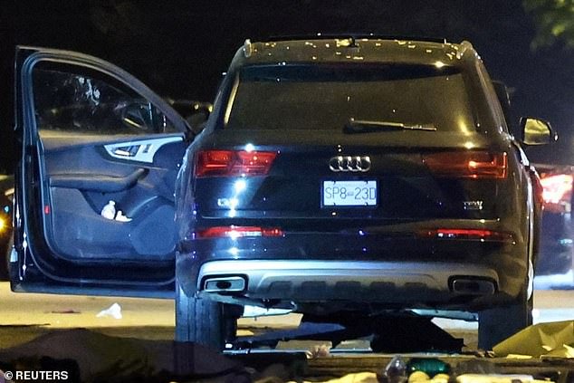 The vehicle is seen with the driver's door open, after it was driven into a crowd