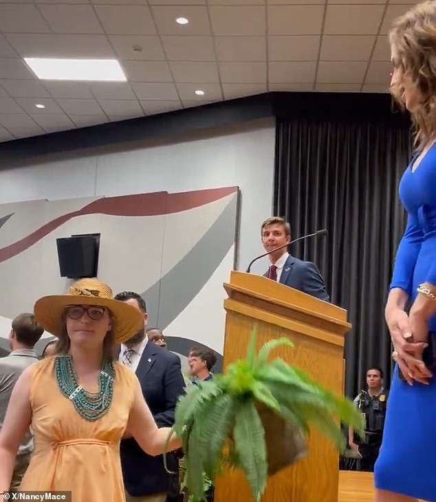 The activist picked up a pot plant and appeared to be contemplating throwing it after Mace disagreed with her