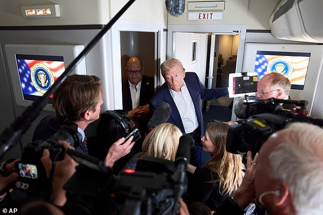 President Donald Trump speaks with reporters on Air Force One as he travels to attend the funeral of Pope Francis
