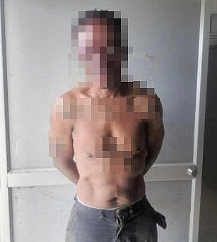 A picture of the reportedly British man when he was in police custody. His identity has been obscured pending formal identification