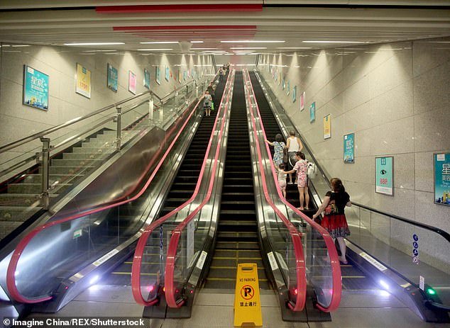Passengers stand on an escalator at Hongtudi Subway Station which is 60 meters underground, of Line 6, in Chongqing Deepest subway station, Hongtudi, which is 60 meters underground, of Line 6, in Chongqing, China