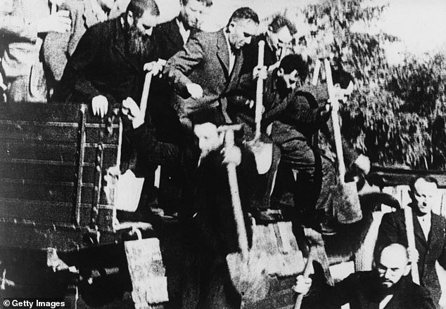 Jewish men arrive for forced labor as demolition workers in Nazi-occupied Poland in the early 1940s
