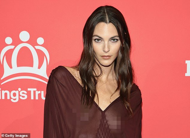 As for her glam, the runway maven paired sultry brown eyeshadow with a bare lip and wore her brunette hair in loose, voluminous waves