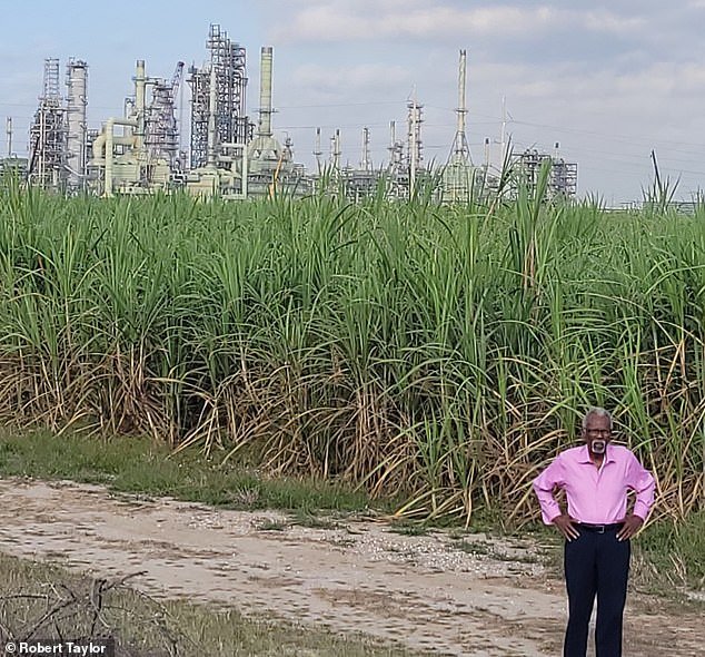 Robert Taylor stands in St. John the Baptist Parish where he said once worked in the sugarcane field with the Marathon facility in the background