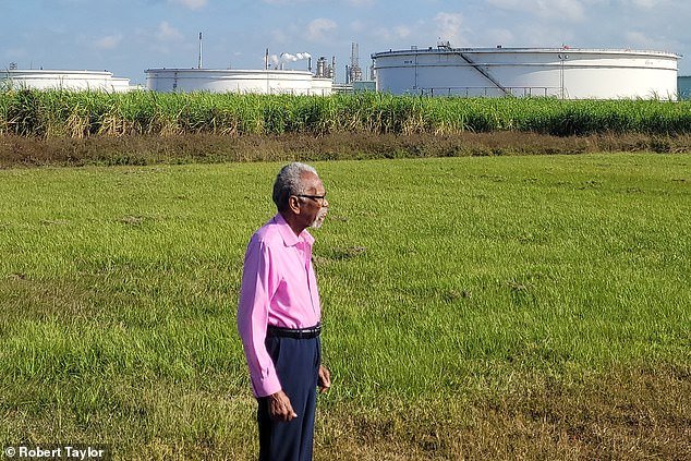 Robert Taylor (pictured) remembers a time before there were factories like the ones seen in the background and is fighting back against more cropping up in St John the Baptist Parish