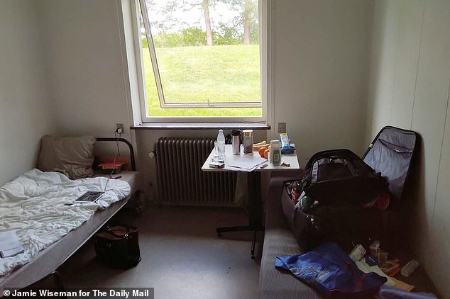 Ndam's room in the deportation centre, with a single bed and small sofa
