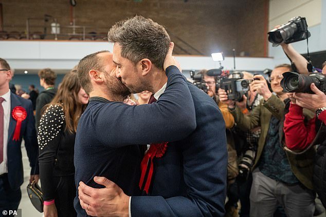Mr Egan is congratulated by his husband after emerging victorious last night