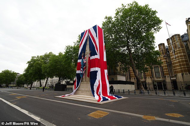 The Cenotaph on Whitehall is dressed in the Union flag as final preparations are made ahead of the military procession today
