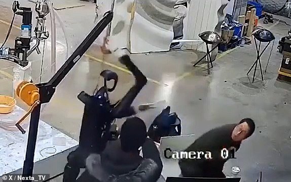 As it flew into a rage and lashed out, a man sitting behind a nearby computer began ducking while another man standing behind the robot backed away