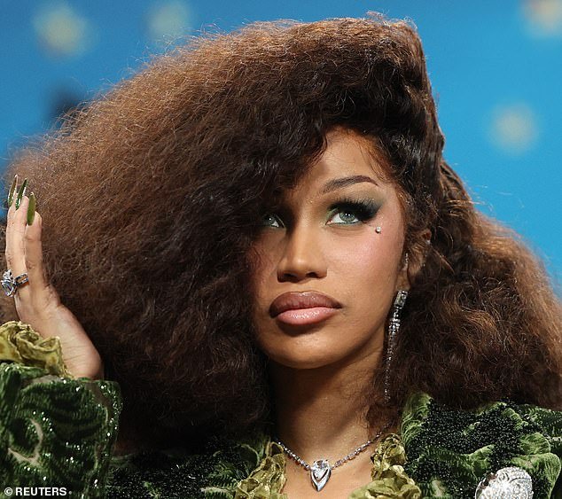 Cardi was even wearing green contact lenses to match the rest of her look