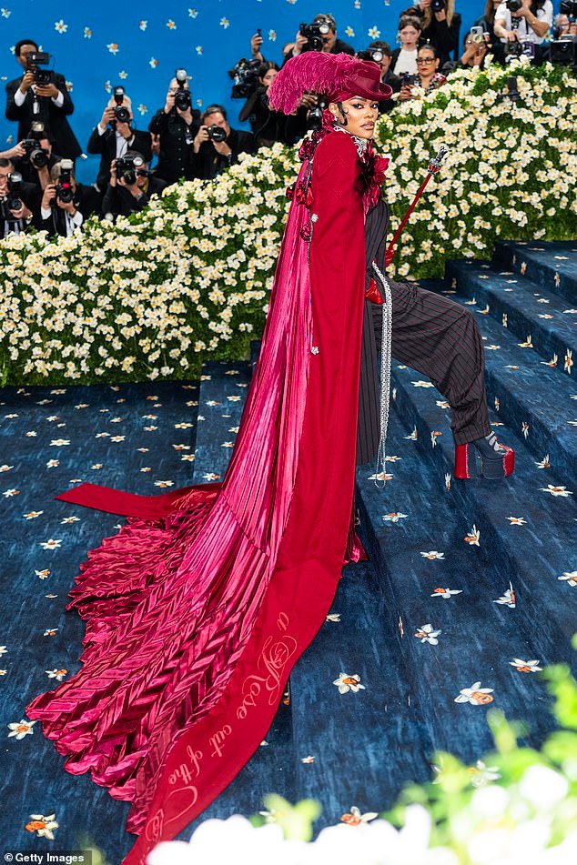 Her flamboyant burgundy cape featured the words 'Harlem Rose' hand-stitched on the train