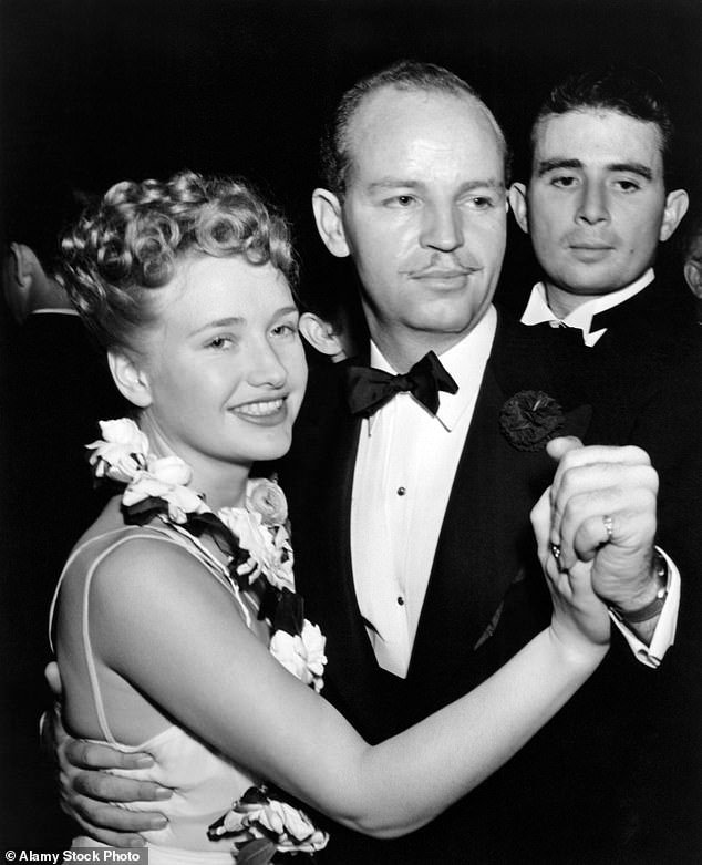 Oren W. Haglund was discharged in December 1945 and became a production manager of TV shows. He died in 1972 aged 66. Above: With his fiancee, the actress, Priscilla Lane in 1939. The couple divorced in 1941
