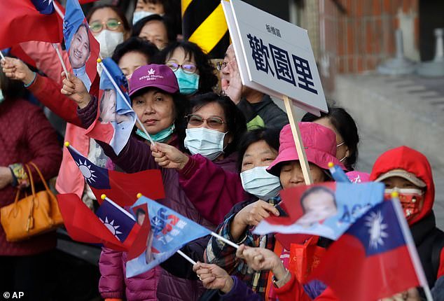 Supporters of Taiwan's Nationalist Party presidential candidate Hou Yu-ih cheer during his car campaign in New Taipei, Taiwan, Thursday, January 11, 2024