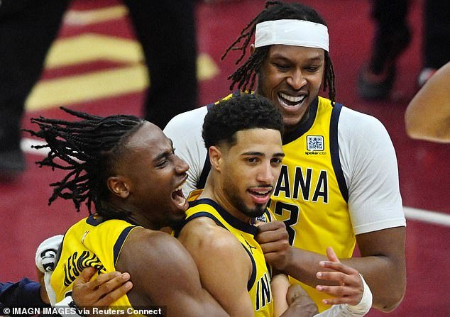 Haliburton (center) celebrates the game-winner with Aaron Nesmith (left) and Myles Turner