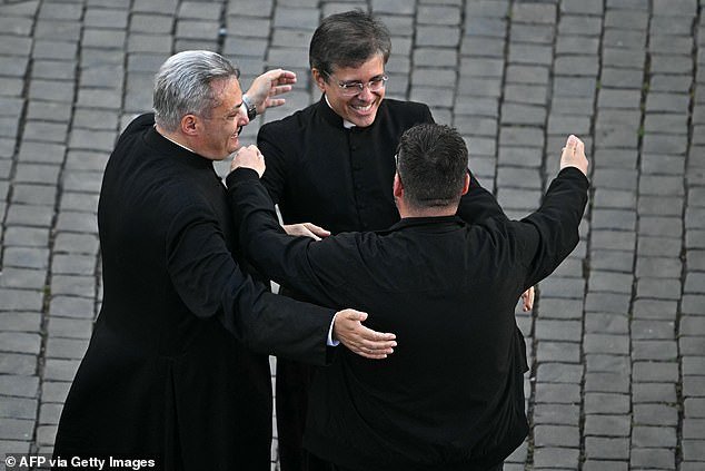 Prelates celebrate on St Peter's Square as cardinals signaled they elected a new pope during their conclave