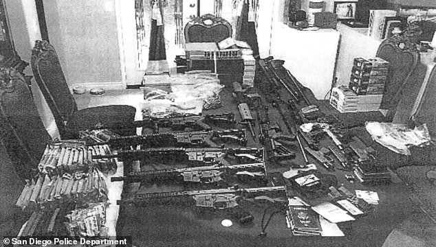 Authorities released this photo of Larry's stash of weapons and four passports. They reported the haul included two illegally-owned AR-15 rifles