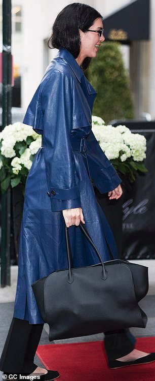 Jenner had on a cobalt blue leather coat with black slacks and ballet flats holding a large purse