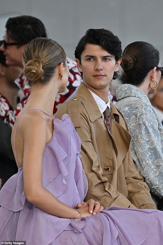 Nikolai exuded sophistication in a tan overcoat pair with a crisp white shirt and a stylish patterned tie
