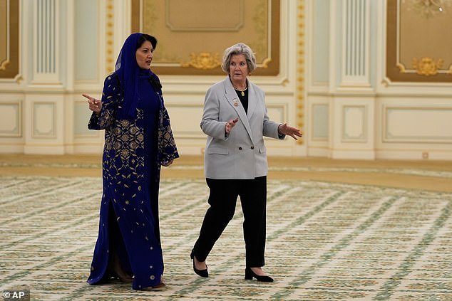 White House Chief of Staff Susie Wiles (right) sported a baby blue oversized blazer over a black top and paired the look with black tapered trousers and a black block heel. She walks alongside Reema bint Bandar Al Saud (left), Saudi's ambassador to the United States