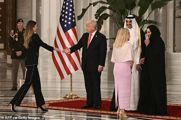 Longtime aide Margo Martin (left) can be seen greeting President Donald Trump in the receiving line wearing a black pantsuit and high heels
