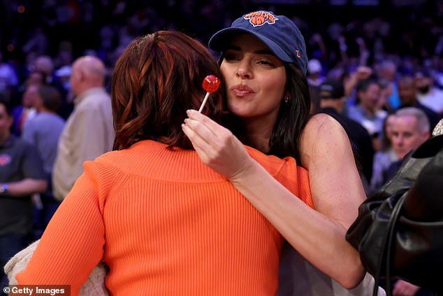 Model Kendall opted for a similar look, also wearing leather trousers with a white vest top heels and a blue Knicks cap for the sporting occasion