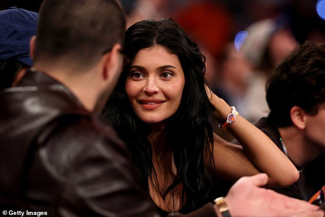 Kylie cut a sexy figure in a form-fitting black vest top which she styled with leather trousers and a pair of strappy heels