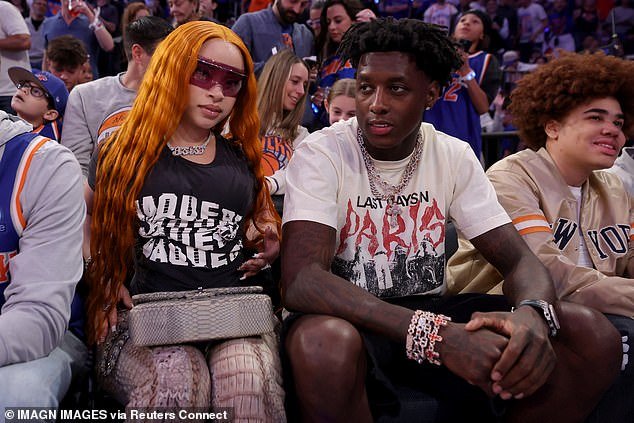 Rapper Ice Spice (L) and New York Jets cornerback Sauce Gardner (R) watch courtside