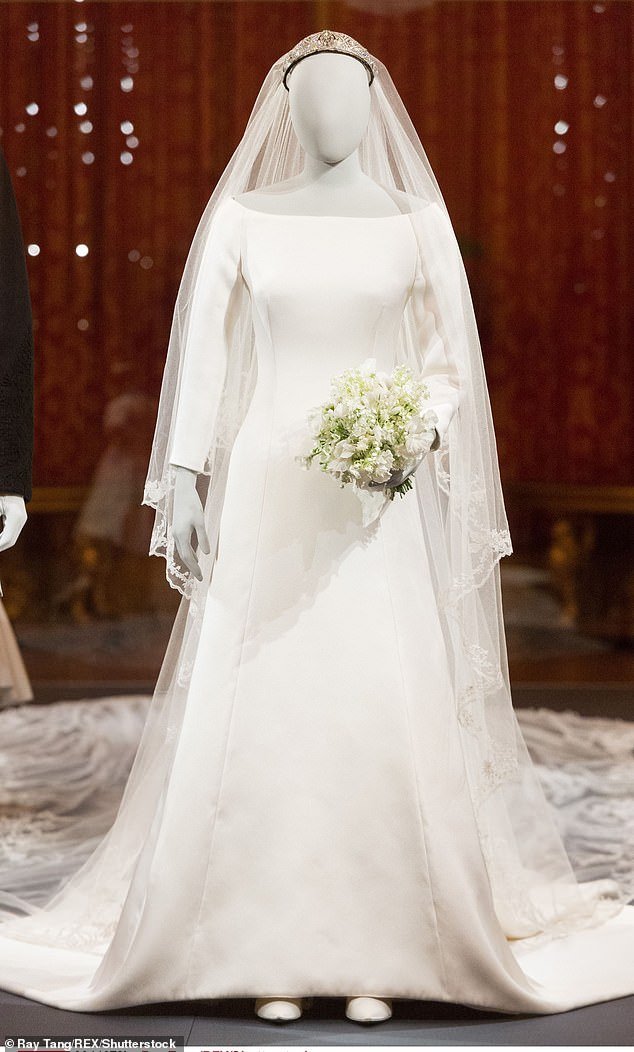 Meghan's wedding dress is pictured at The Royal Collection at Windsor Castle 'A Royal Wedding: The Duke and Duchess of Sussex' exhibition in October 2018