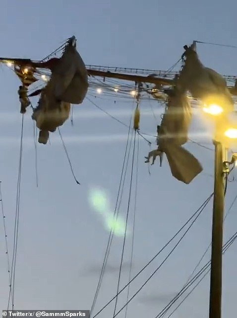 Sailors perched high above are thrown into chaos, with some seen clinging to the shattered beams high up in the air