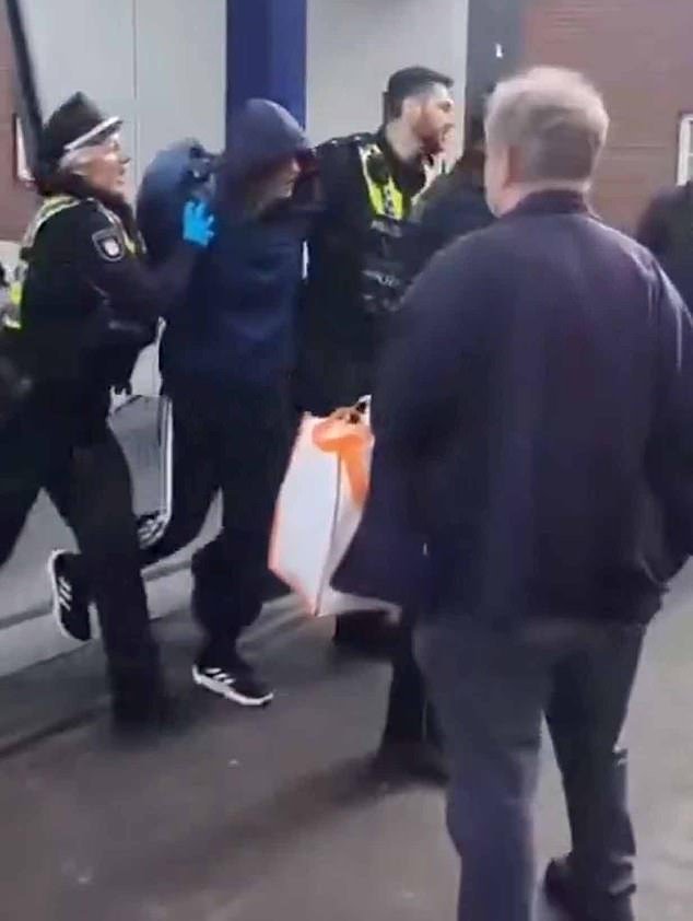 The attacker, who carried out a stabbing spree at the central railway station in Germany's second-biggest city, has been arrested. Police said the assailant was a 39-year-old woman who was believed to have acted alone. Pictured: The suspect being arrested