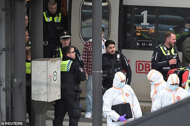 Pictured: Police officers and forensic experts work at Hamburg's main train station