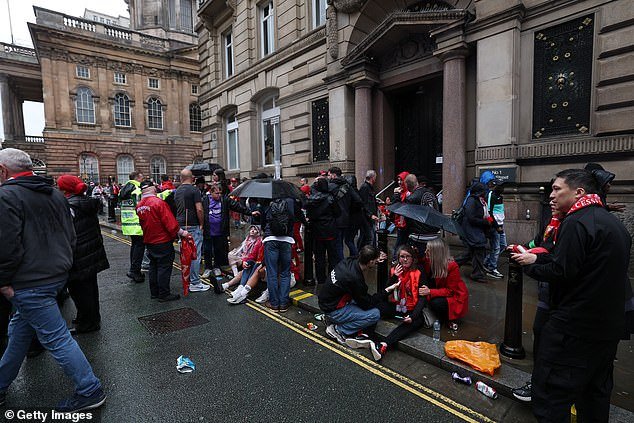 An emergency service presence is pictured as members of the public react on Water Street