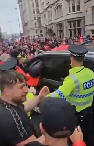 Crowds swarm around the car